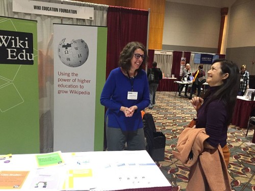 Longtime Wiki Ed participant Jenny Mikulay talks with first time instructor Linh Hua at the Wiki Education Foundation booth at NWSA.