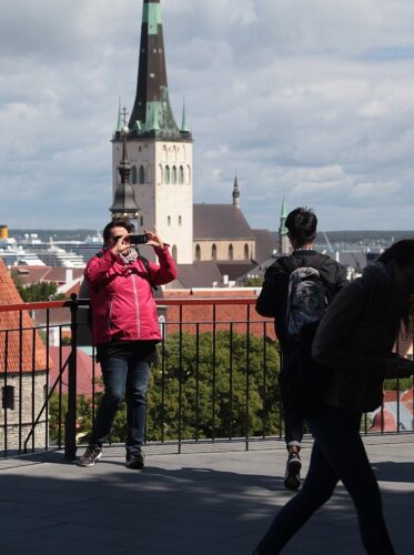 Tourist taking a photo in front of a monument