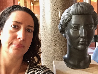 Kate Dimitrova with sculpture of woman's head