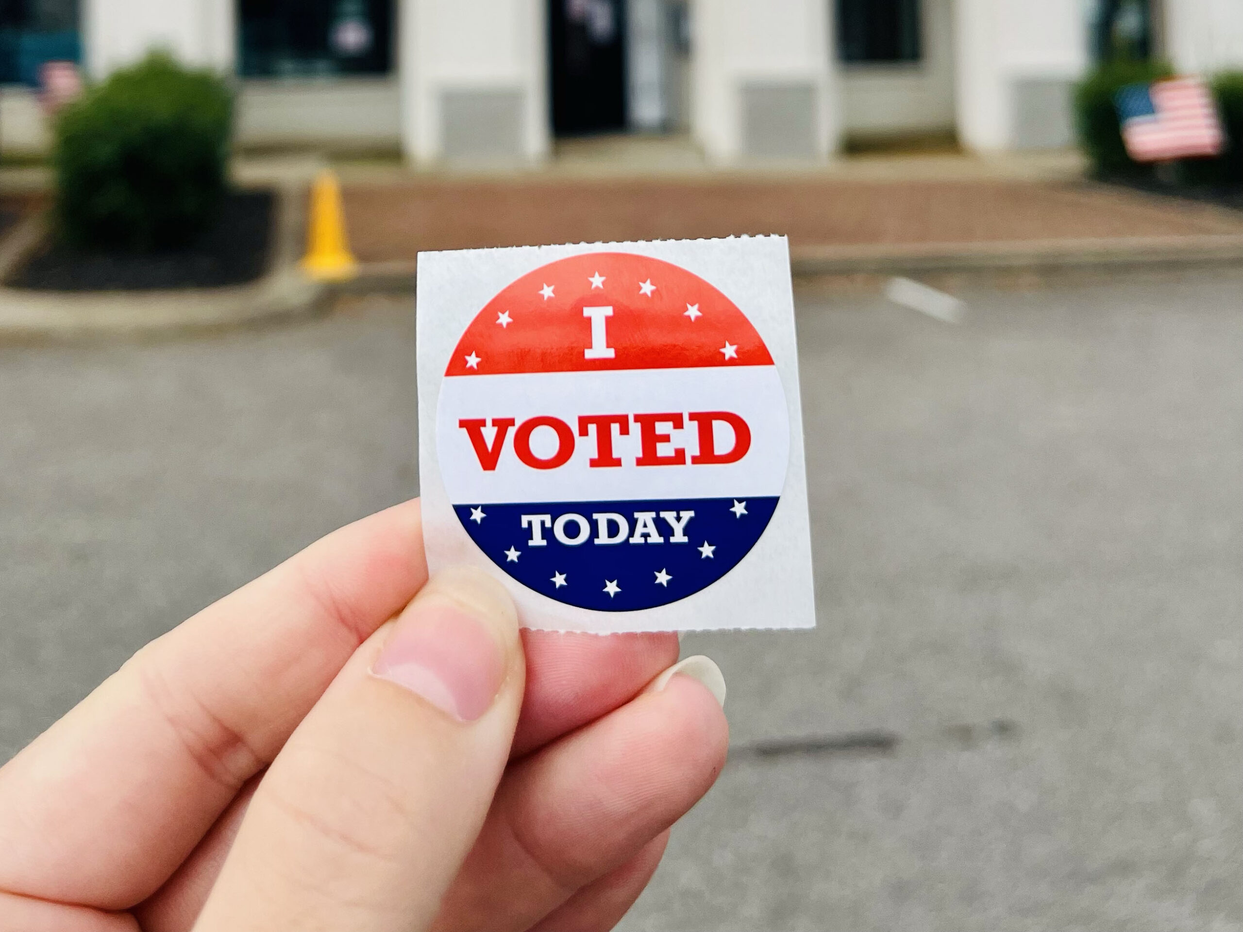 Hand holding I VOTED TODAY sticker